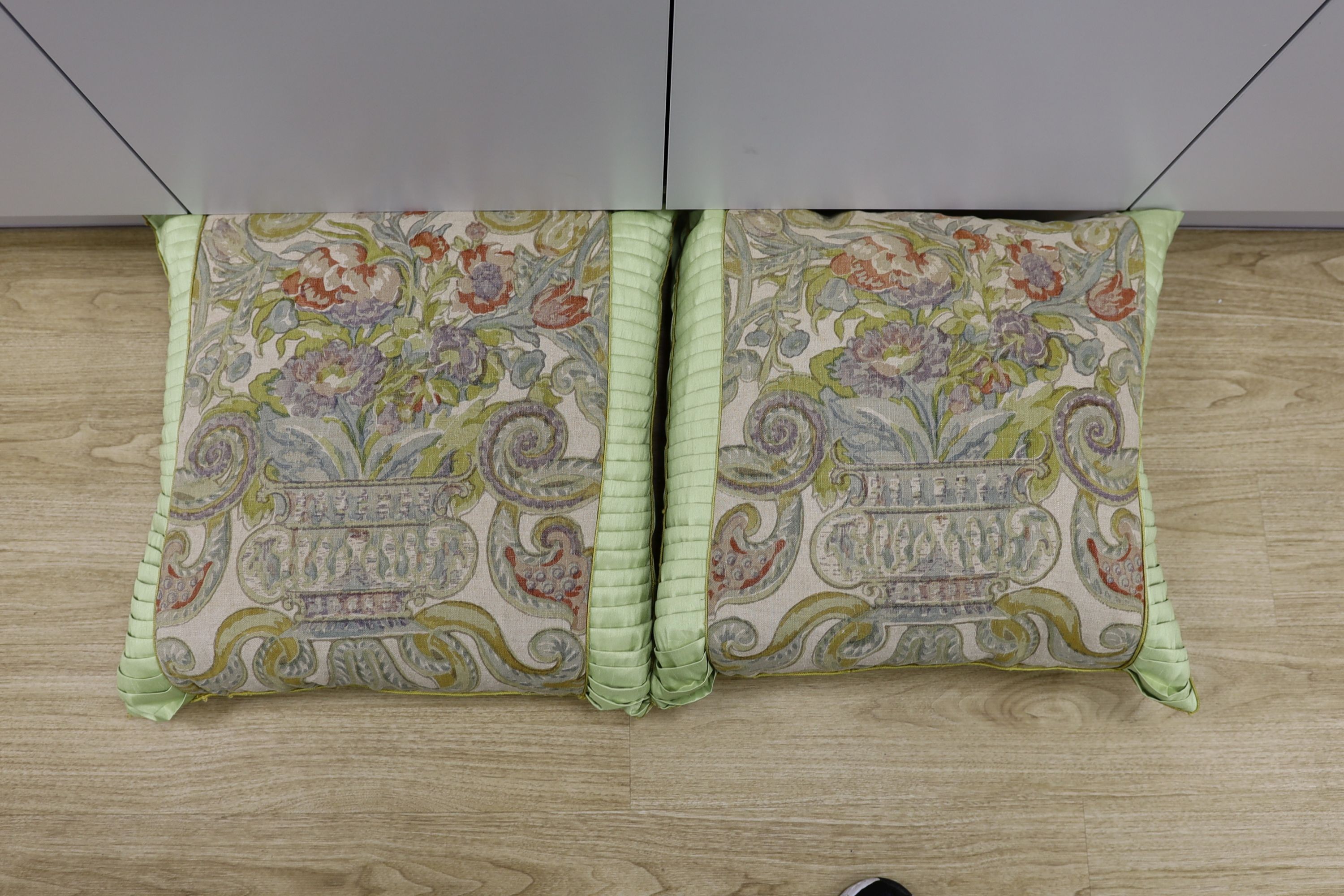 A pair of large fabric cushions
